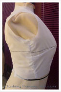 muslin of bodice block on body form with fitting marks
